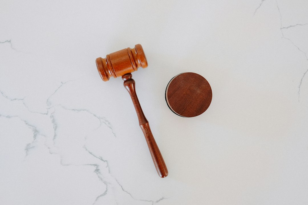 a wooden gavel and a round block on a marble surface